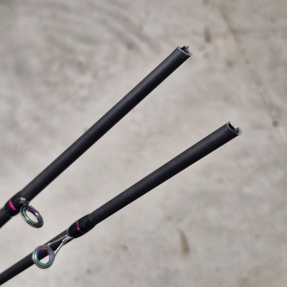 Broken fishing rods pieces on grey background