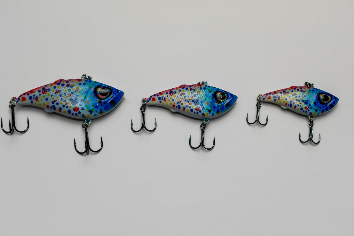 Three colorful fishing lures on a white background