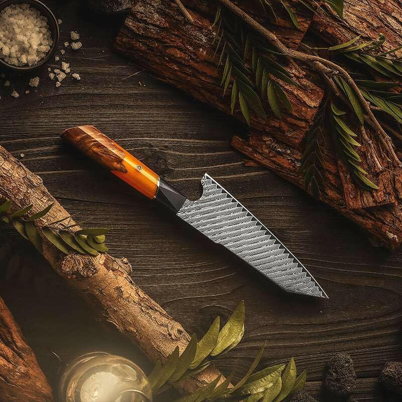 Knife with an orange handle on a wooden surface with logs and leaves
