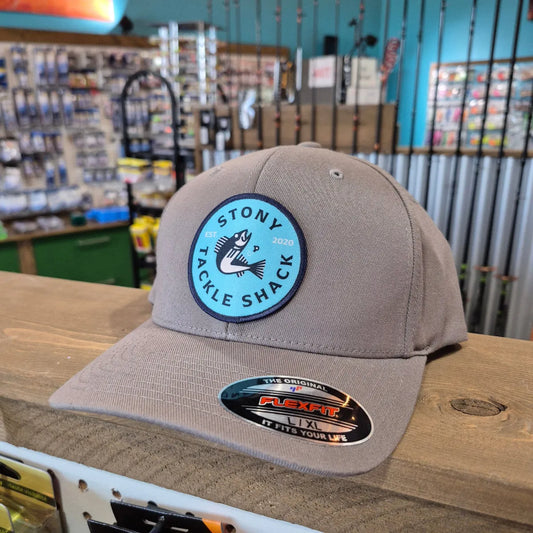 Gray cap with a logo and text on a wooden surface within a store background