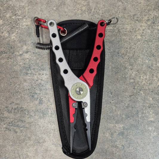 Red and Silver fishing pliers on grey background