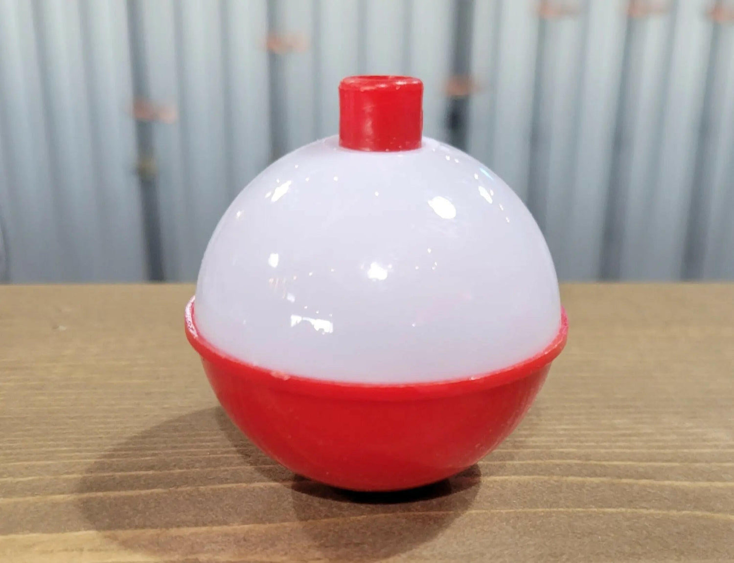 Red/White classic bobber on wood counter top