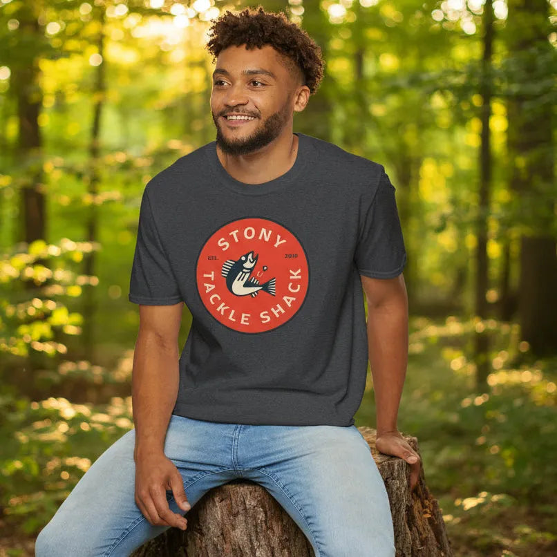 Man wearing a dark grey t-shirt with 'Stony Tackle Shack' logo in a forest setting