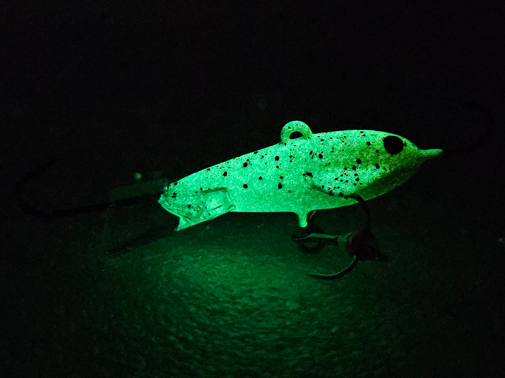 Atomic Bomberz - Bloodsport fishing lure glowing on white background