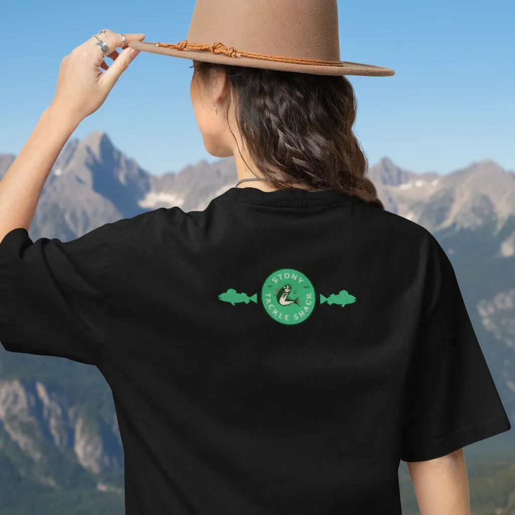 woman wearing a hat and a black t shirt with green logo