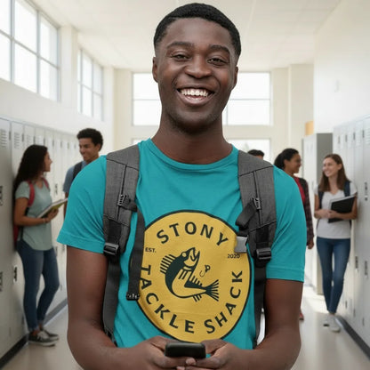 Man wearing a blue t-shirt with a yellow and black logo, holding a phone in a school hallway