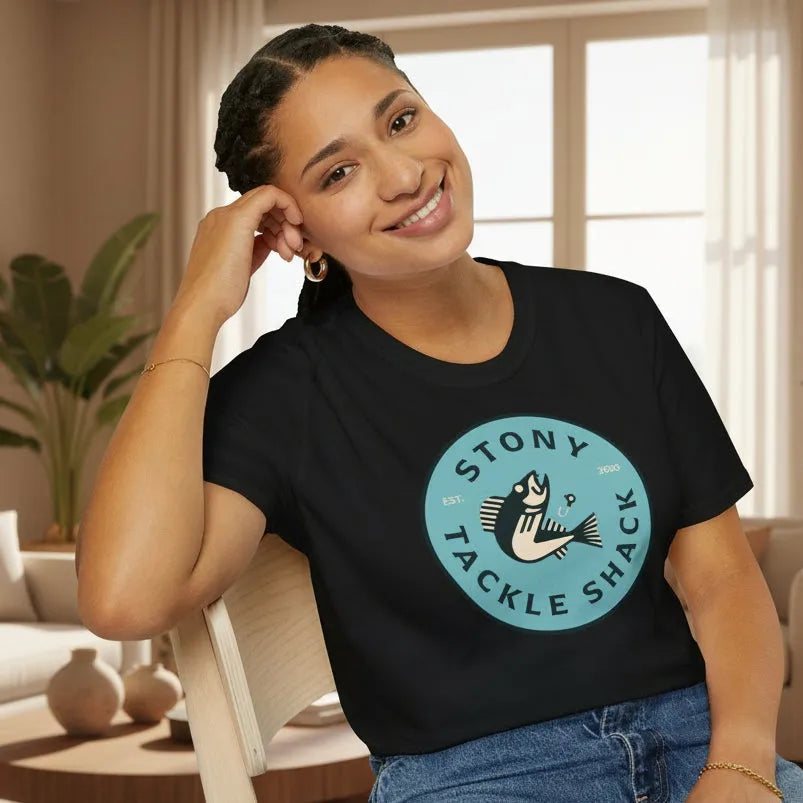 Woman wearing a black t-shirt with 'Stony Tackle Shack' logo, sitting on a chair.