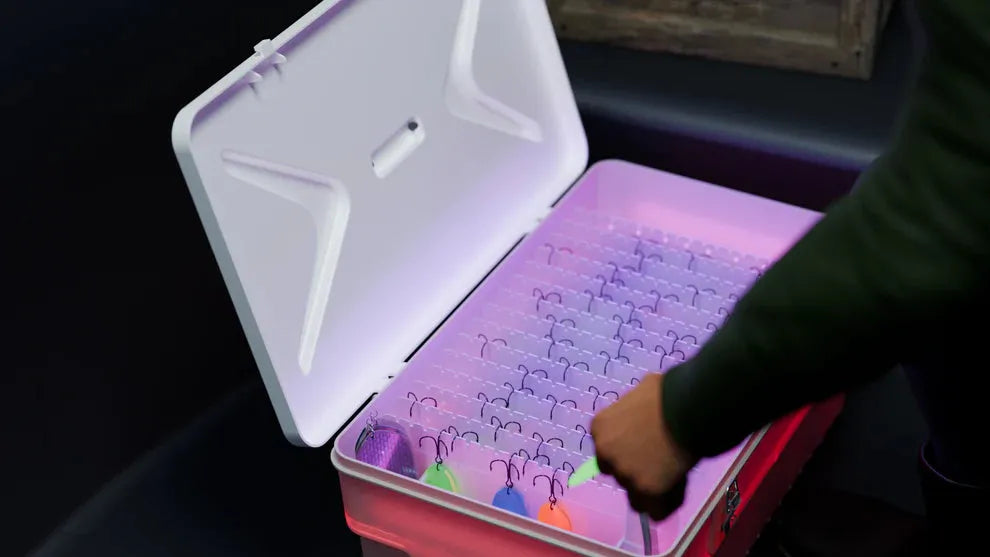 Person interacting with a colorful puzzle inside an open cooler box.