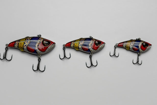 Three colorful fishing lures on a light gray background