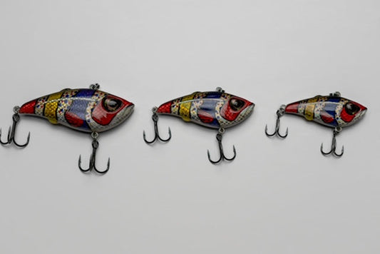 Three colorful fishing lures on a light gray background