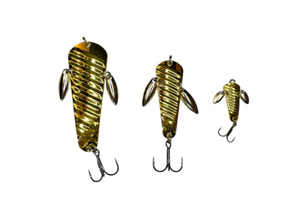 Three gold fishing lures on a white background