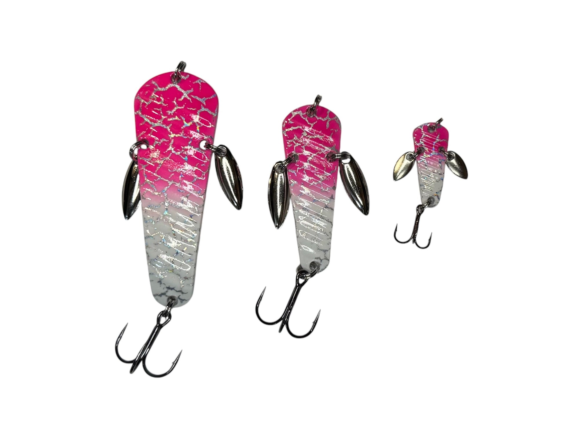 Three pink, white and silver fishing lures on a white background