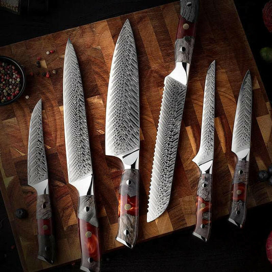 Set of six Damascus knives with decorative handles on a wooden surface