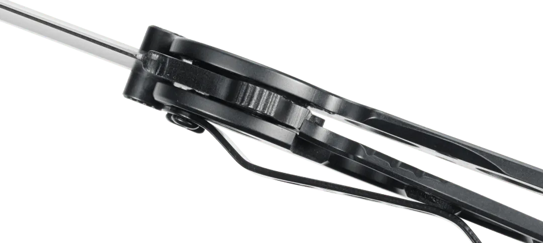 Close-up of a black metal tool with a green background