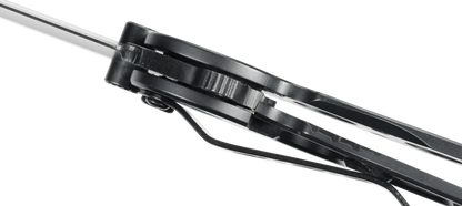 Close-up of a black metal tool with a green background