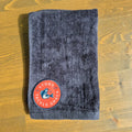 Black hand towel with Red Logo on wood background