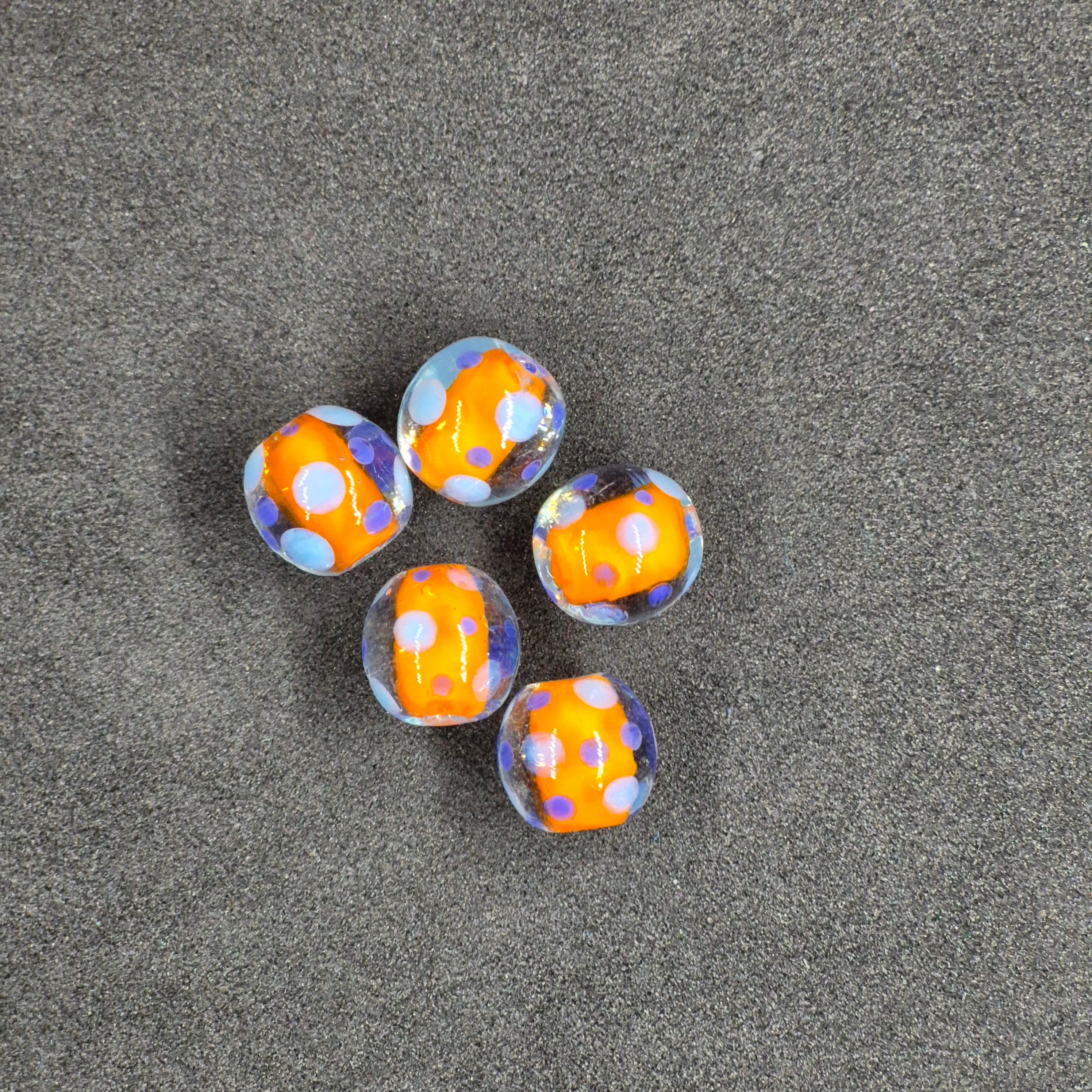 Orange Glass Fishing Beads on Black Background