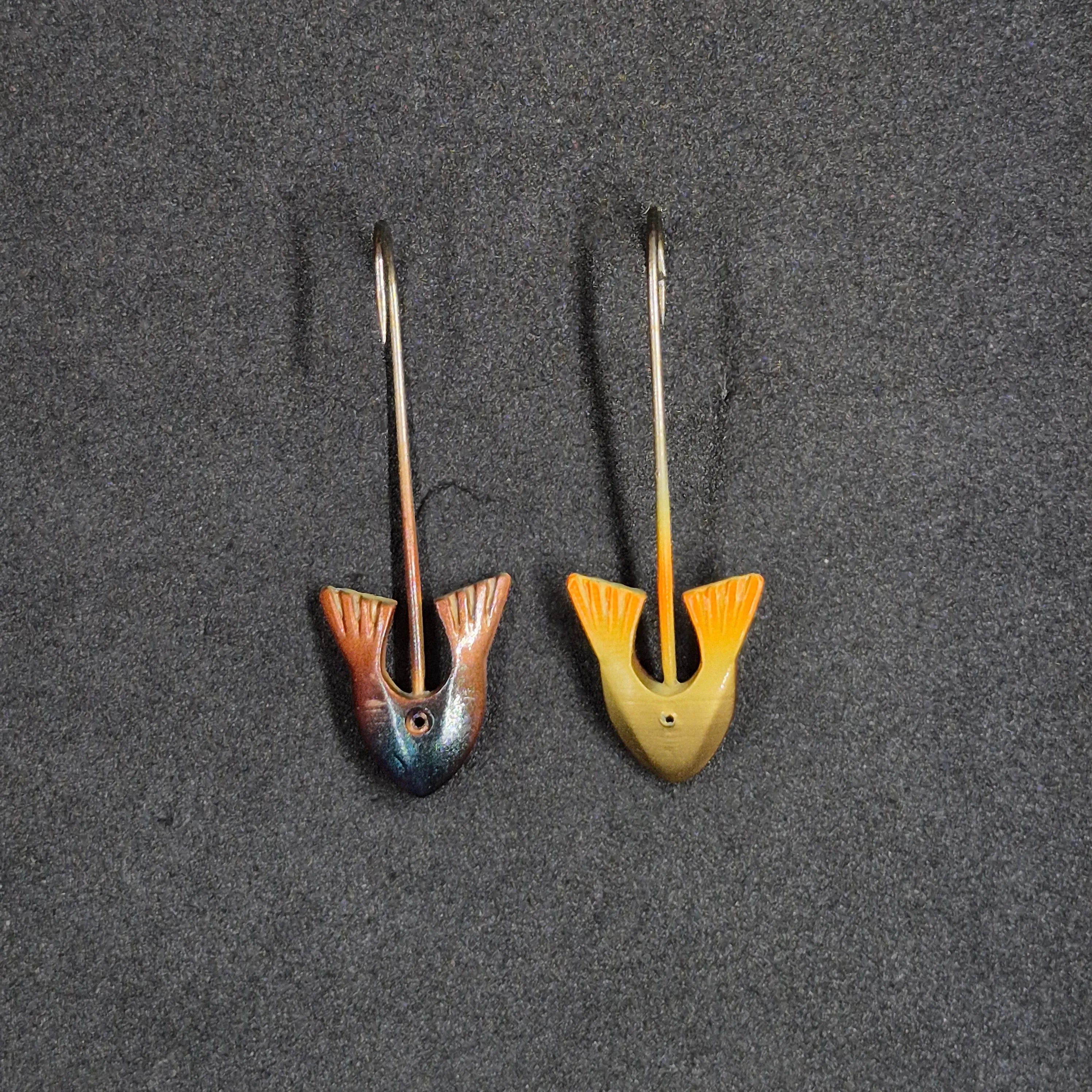 Two fishing lures on a dark textured surface