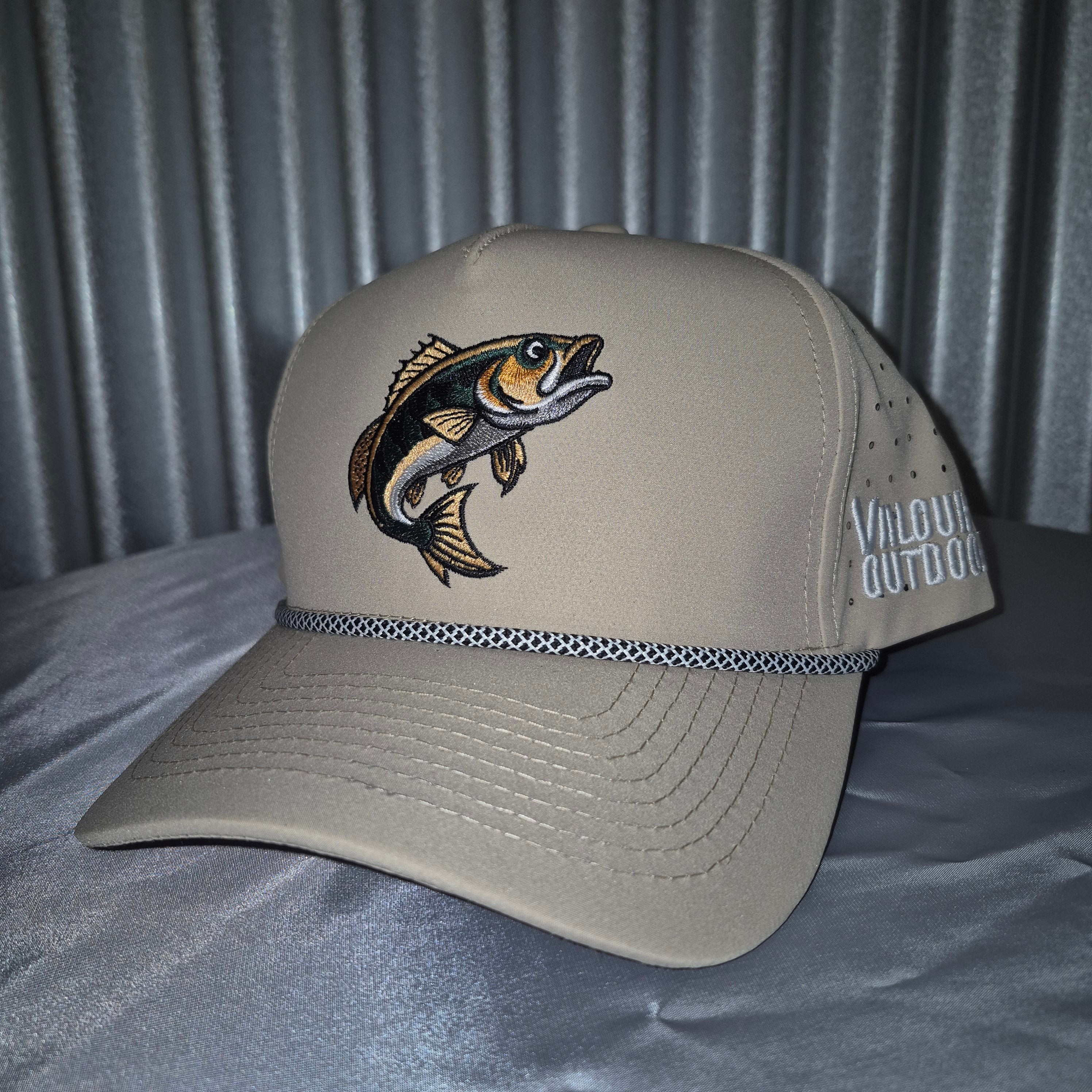 Beige cap with fish emblem on a textured gray background