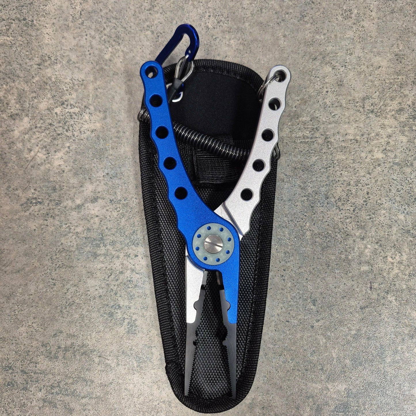 Blue and Silver Fishing pliers on grey background
