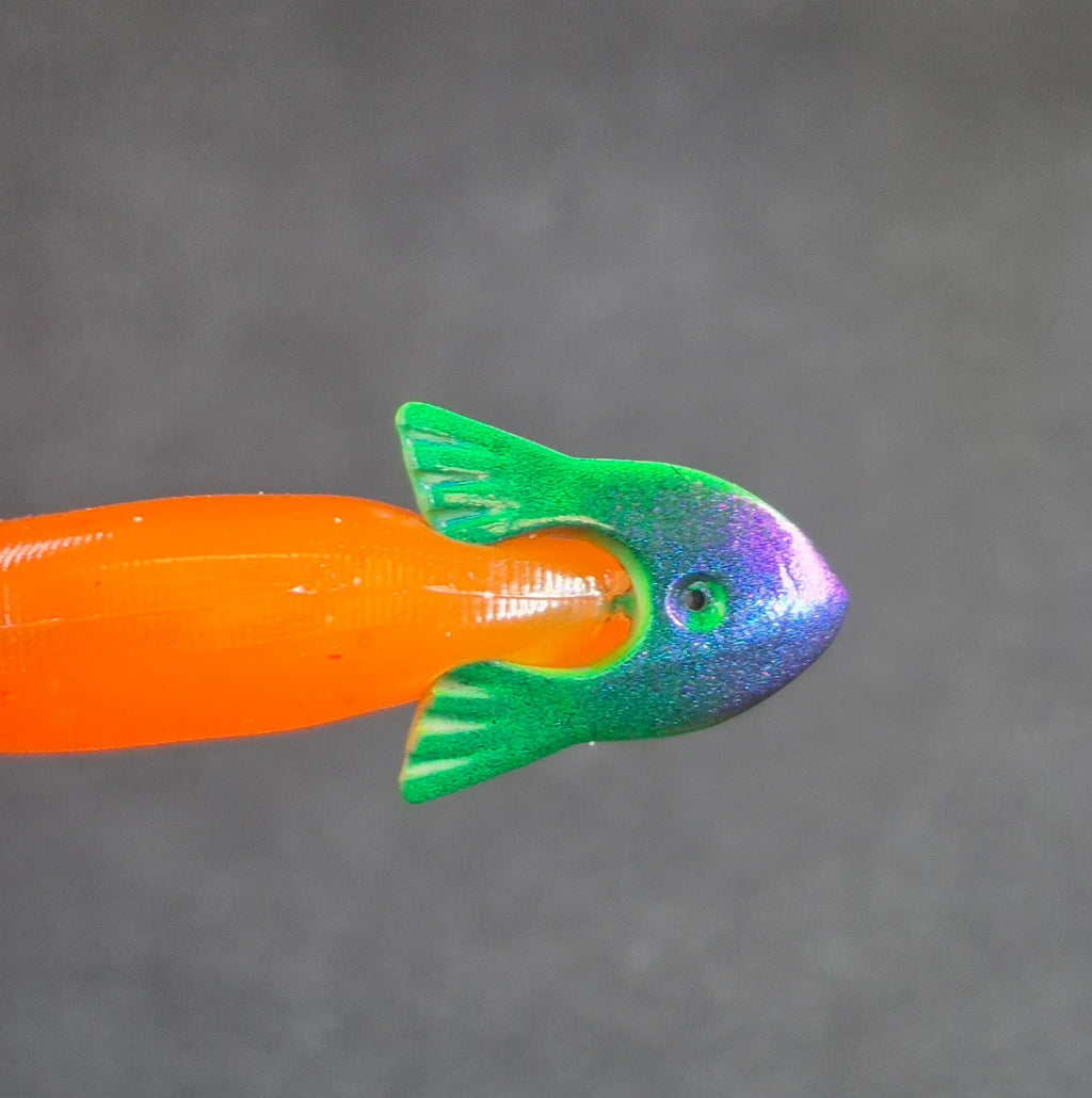 colorful fishing jig head with soft plastic minnow on black background 