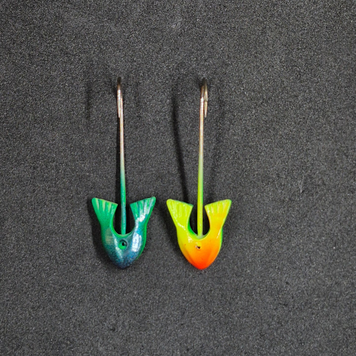 Two colorful fishing jig heads on black background 