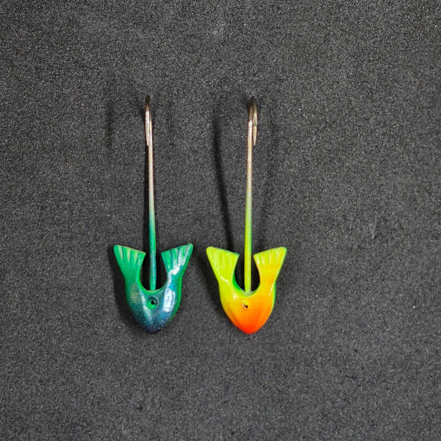 Two colorful fishing jig heads on black background 