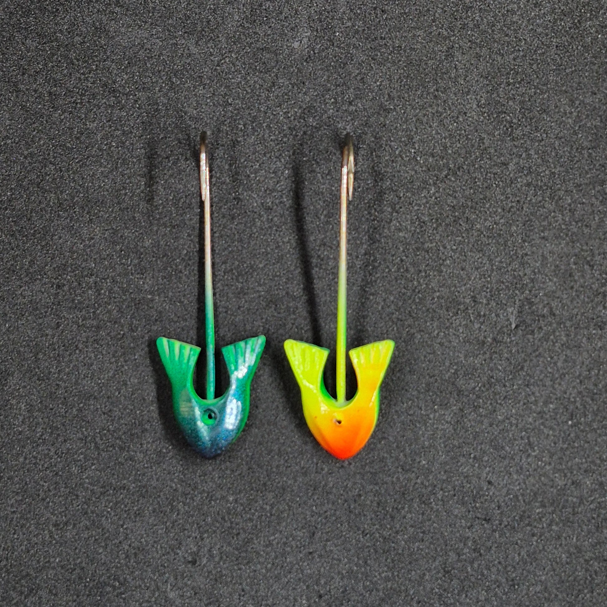 Two colorful fishing jig heads on black background 