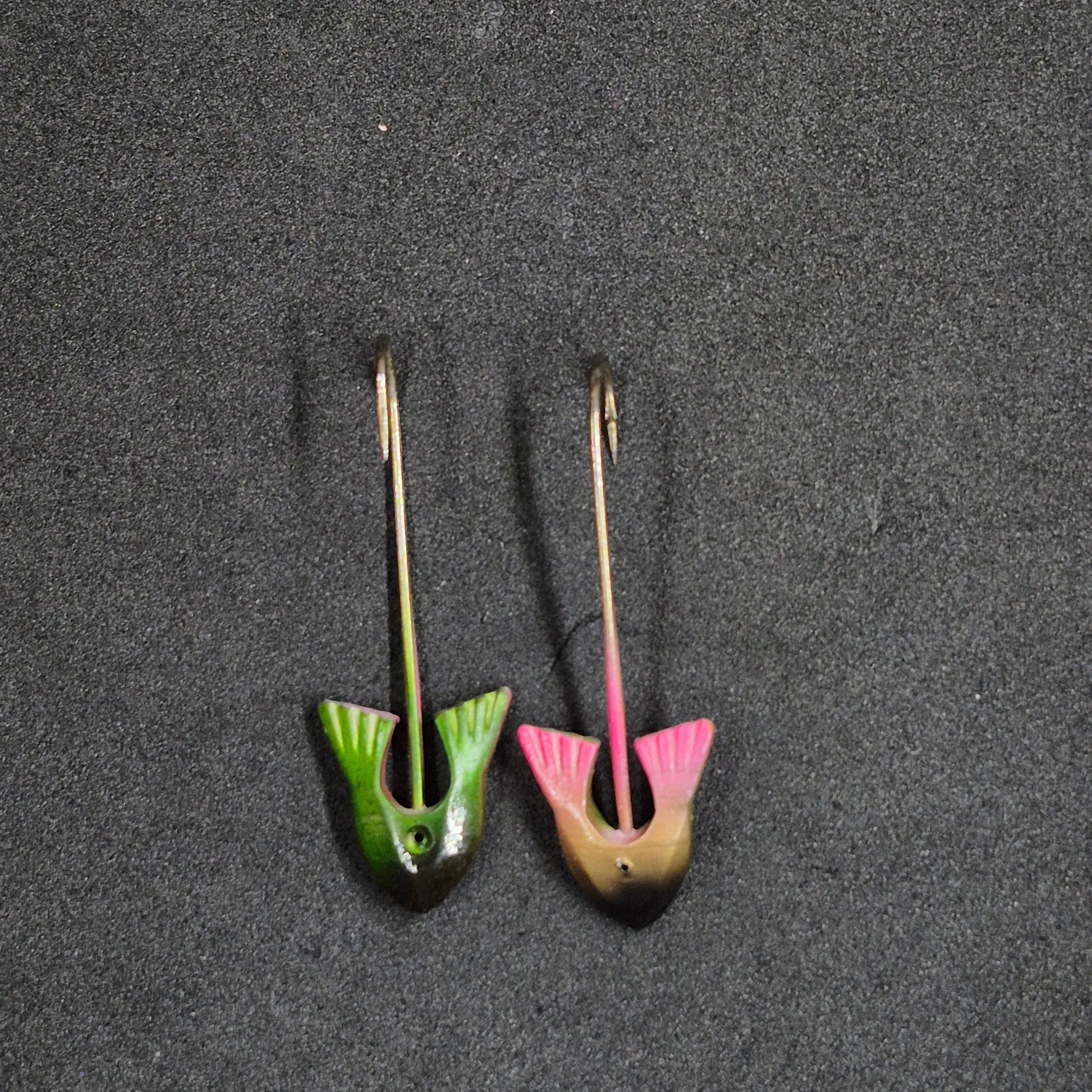 Two colorful fishing jig heads on black background 