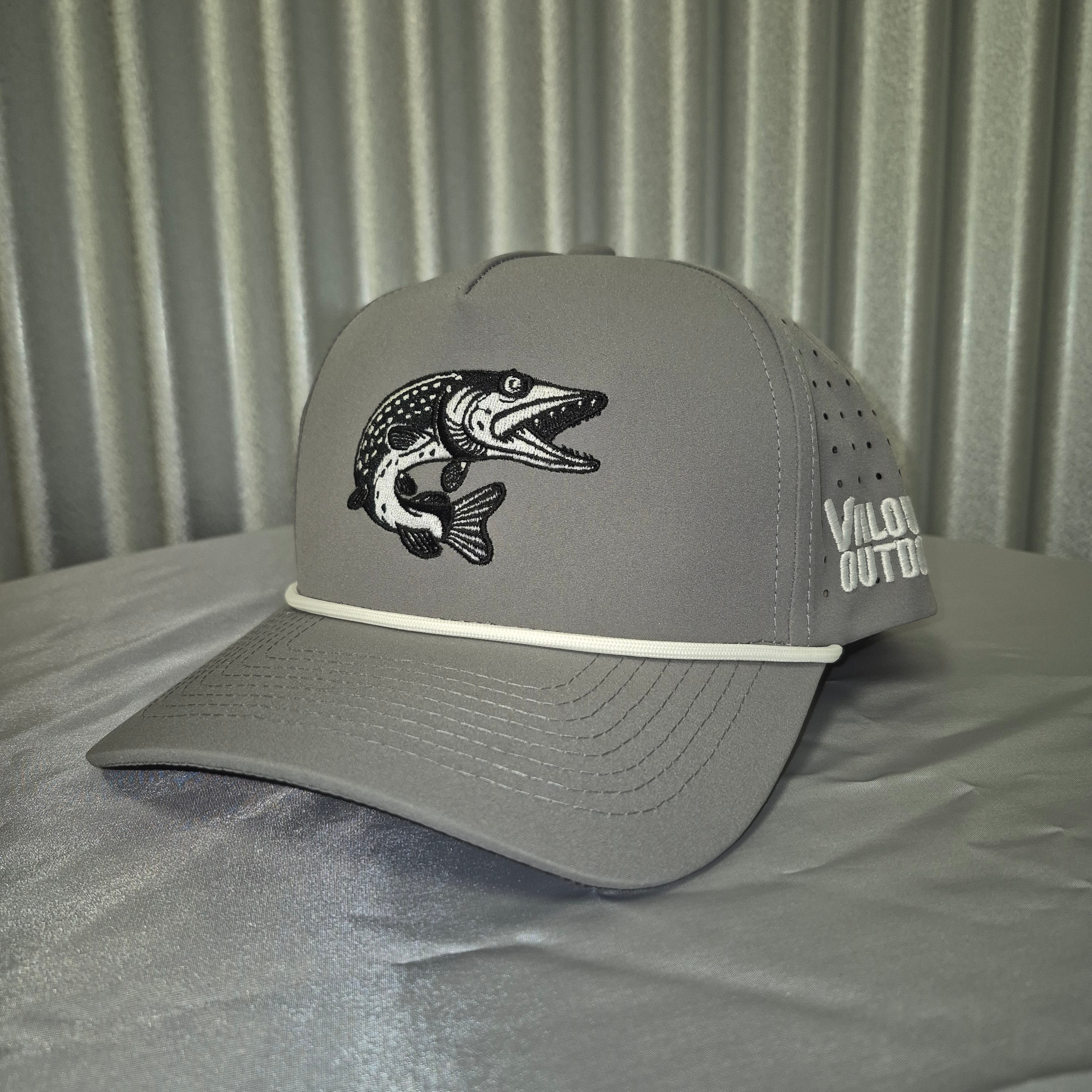 Gray cap with fish emblem on a corrugated metal surface