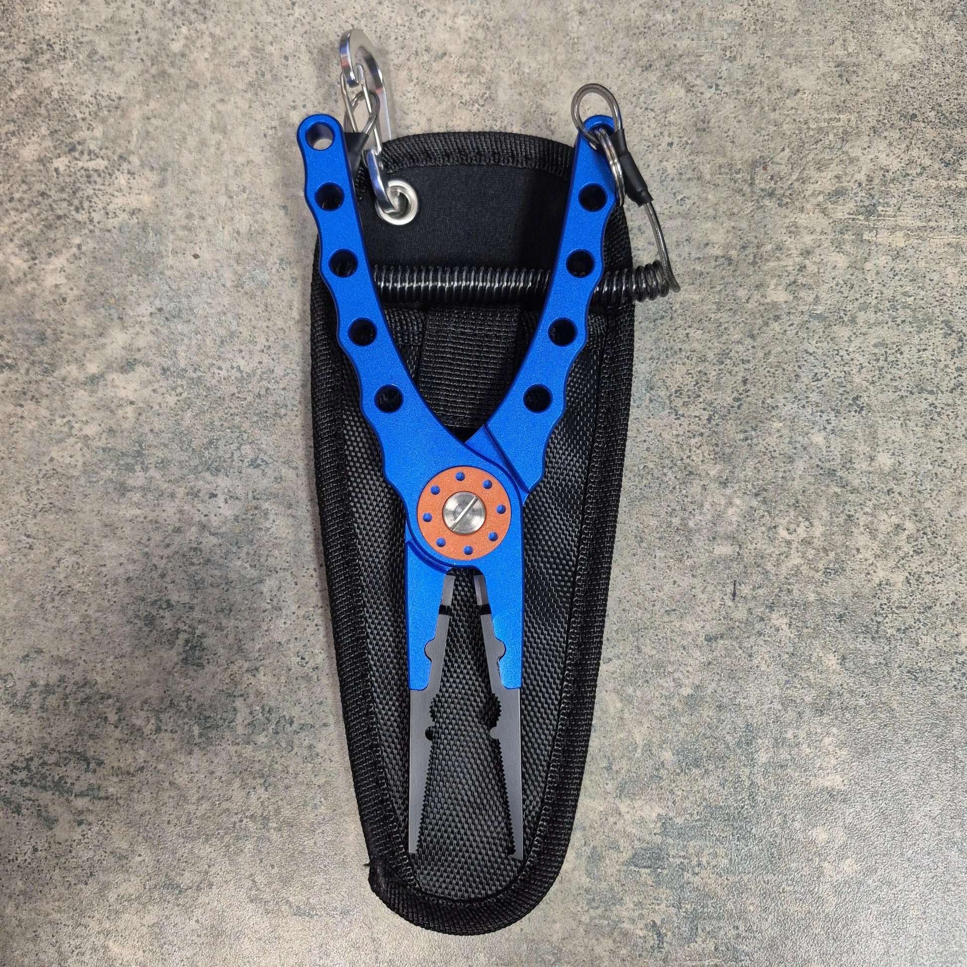 Blue fishing pliers on grey background