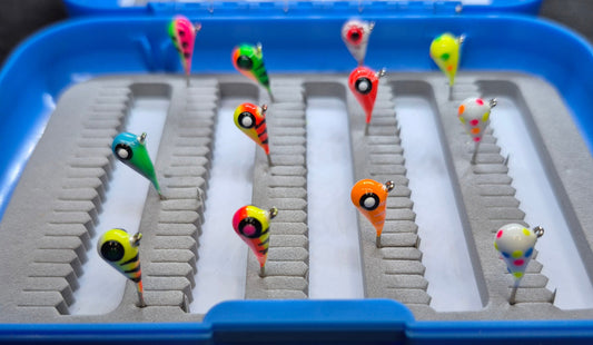 Colorful fishing lures on a tray with a blue border