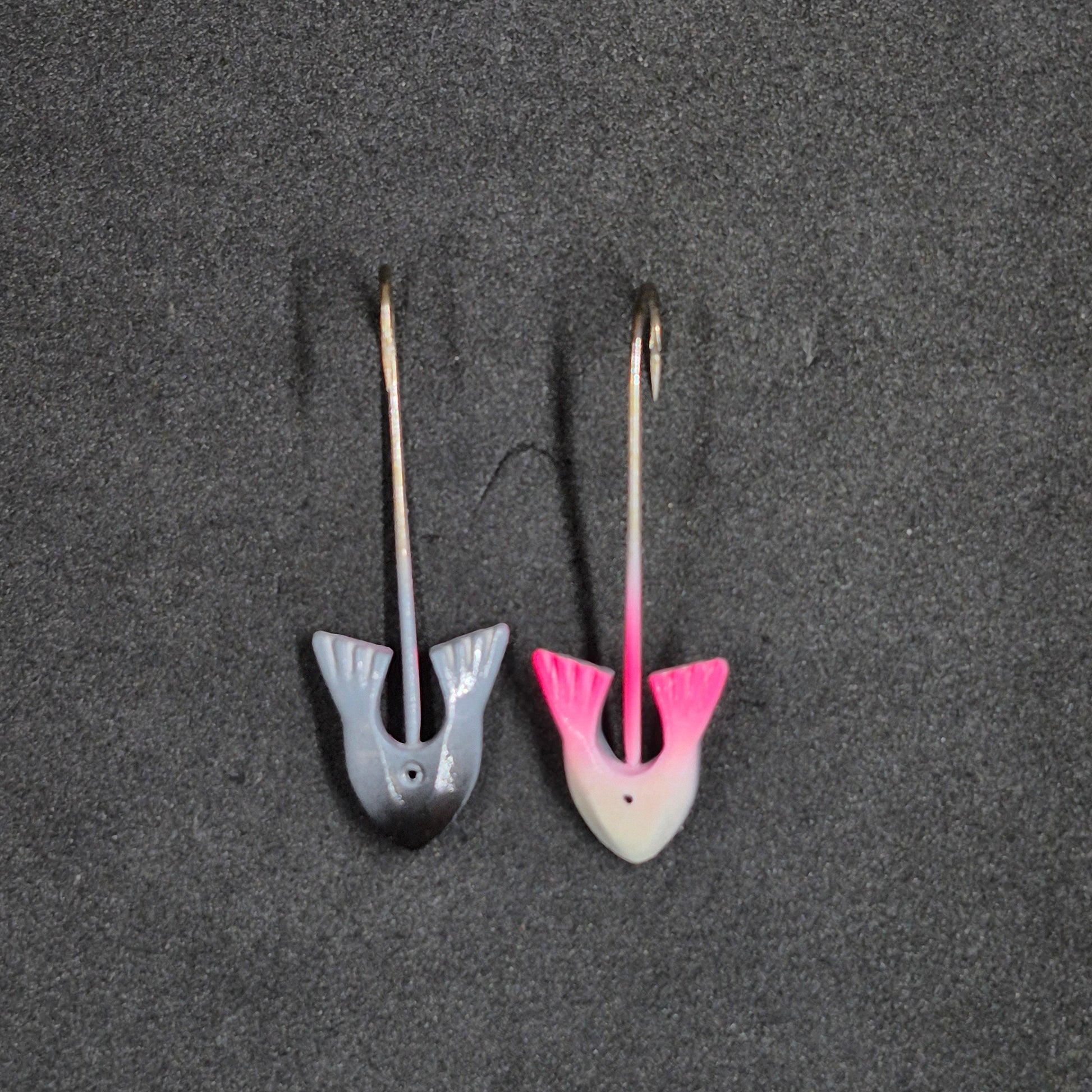 Two colorful fishing jig heads on black background 
