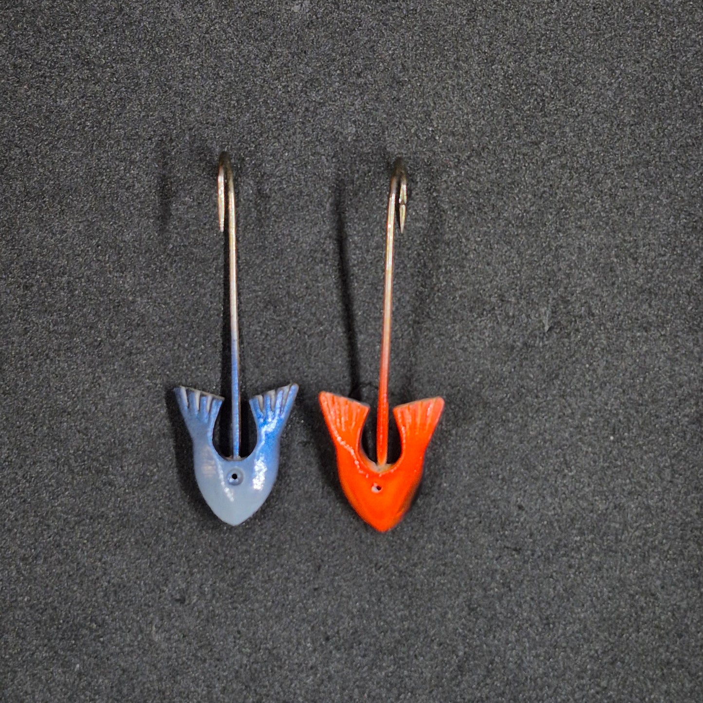 Two colorful fishing jig heads on black background 