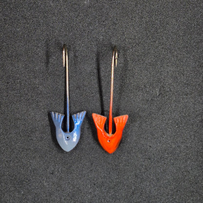 Two colorful fishing jig heads on black background 