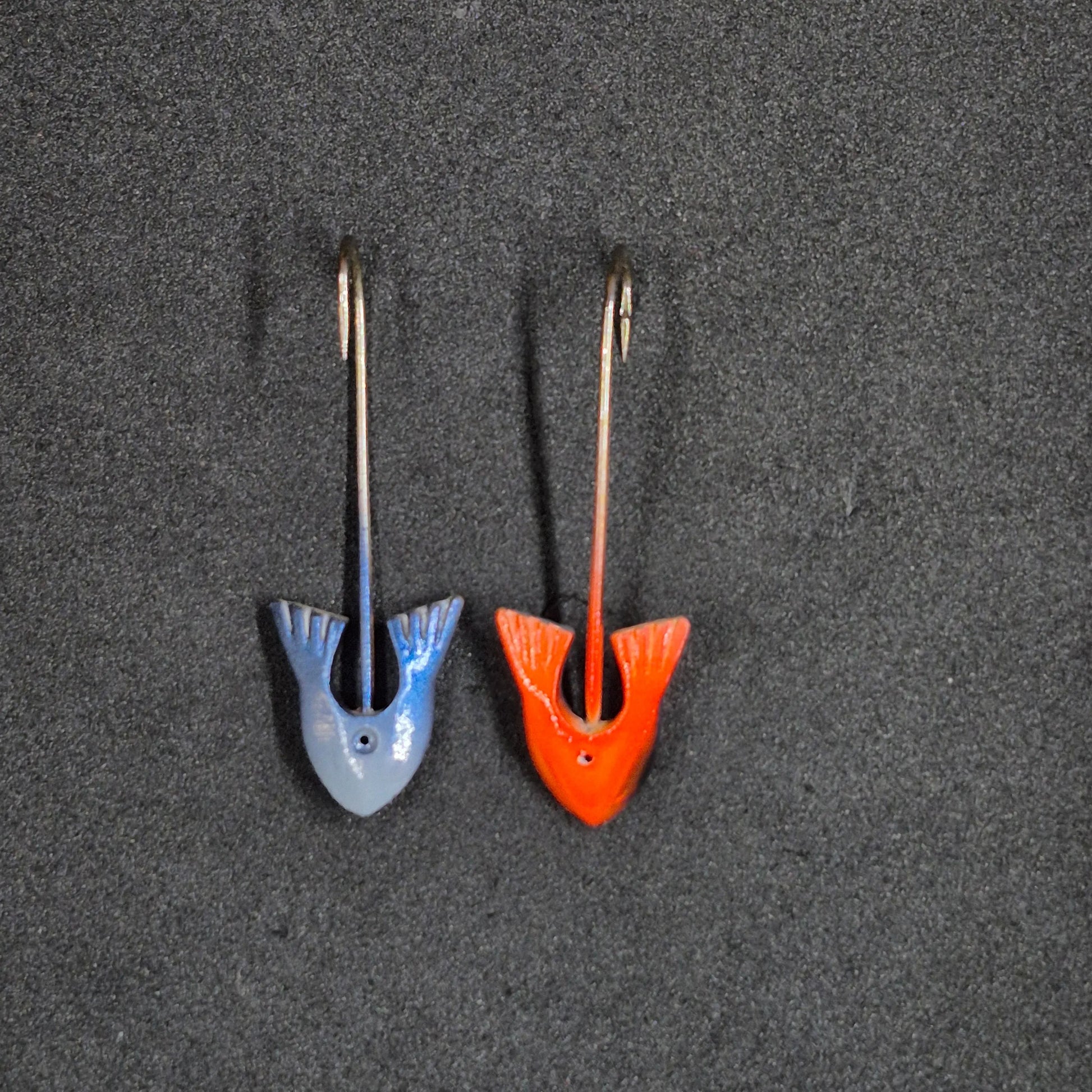 Two colorful fishing jig heads on black background 