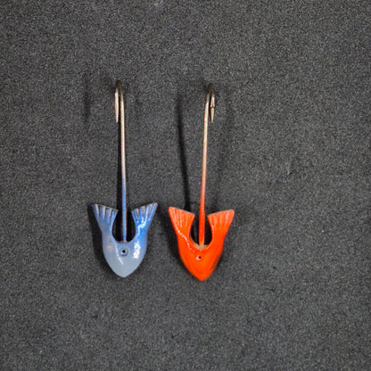 Two colorful fishing jig heads on black background 