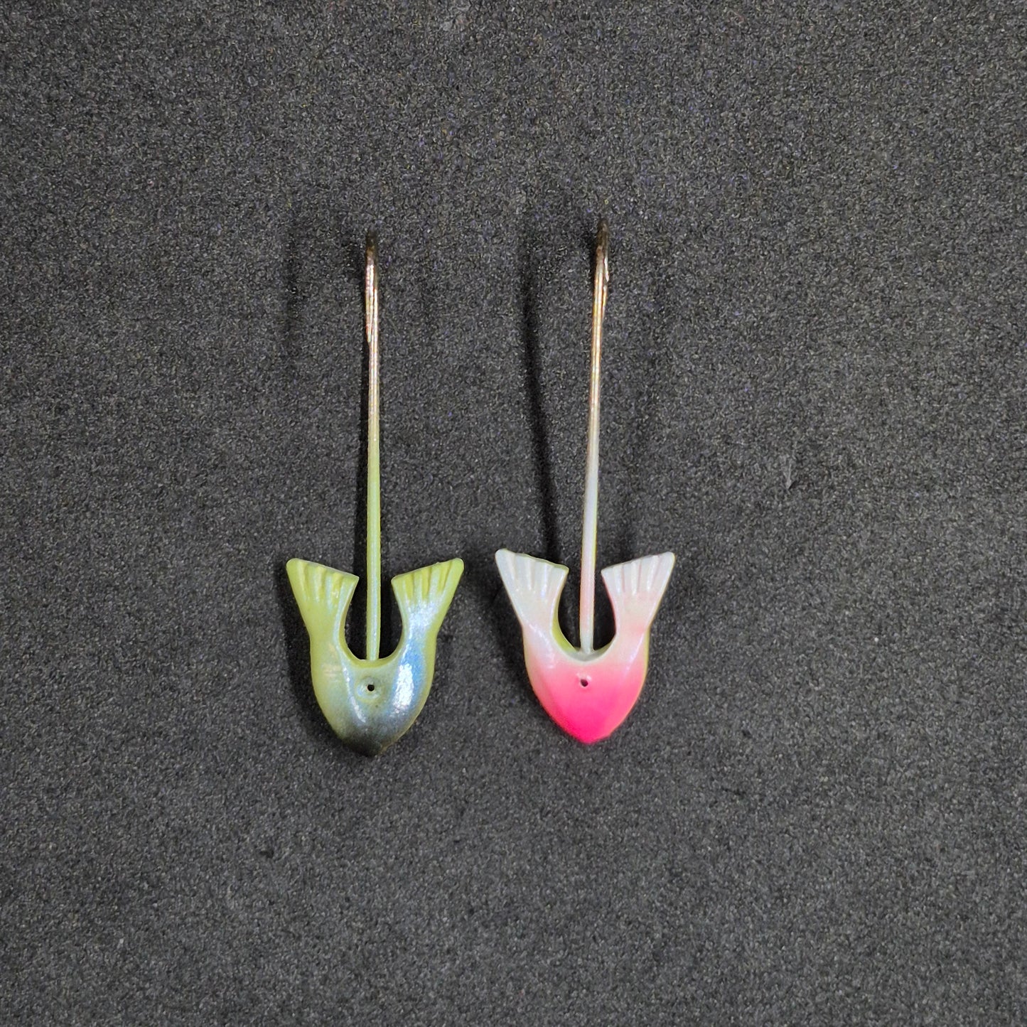 Two colorful fishing jig heads on black background 
