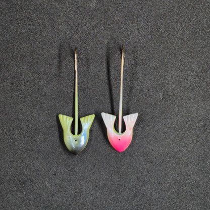 Two colorful fishing jig heads on black background 