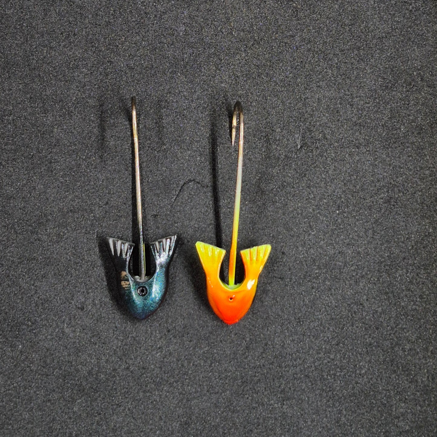 Two colorful fishing jig heads on black background 