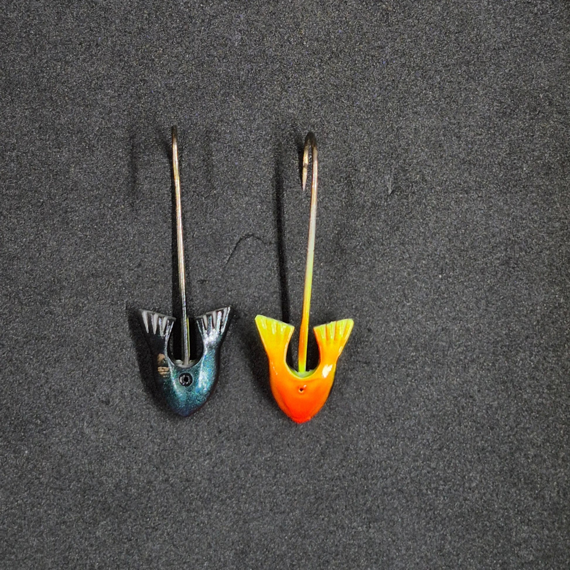 Two colorful fishing jig heads on black background 